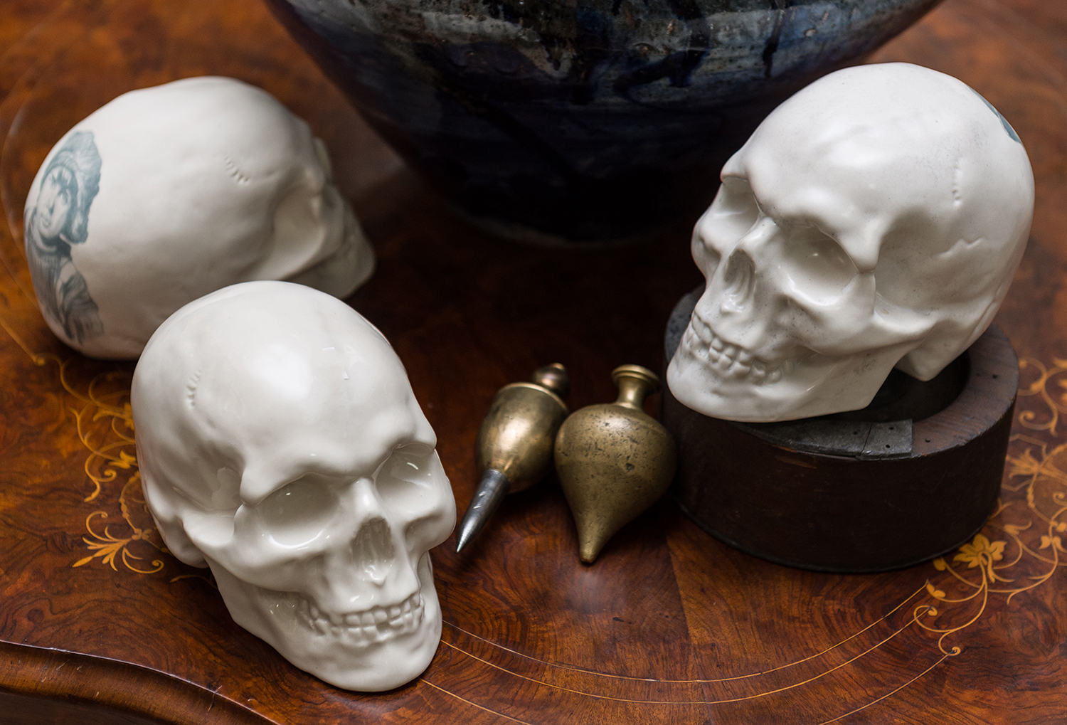 Appraisal: THREE DAVID BROMLEY CERAMIC SKULLS each signed Bromley h x