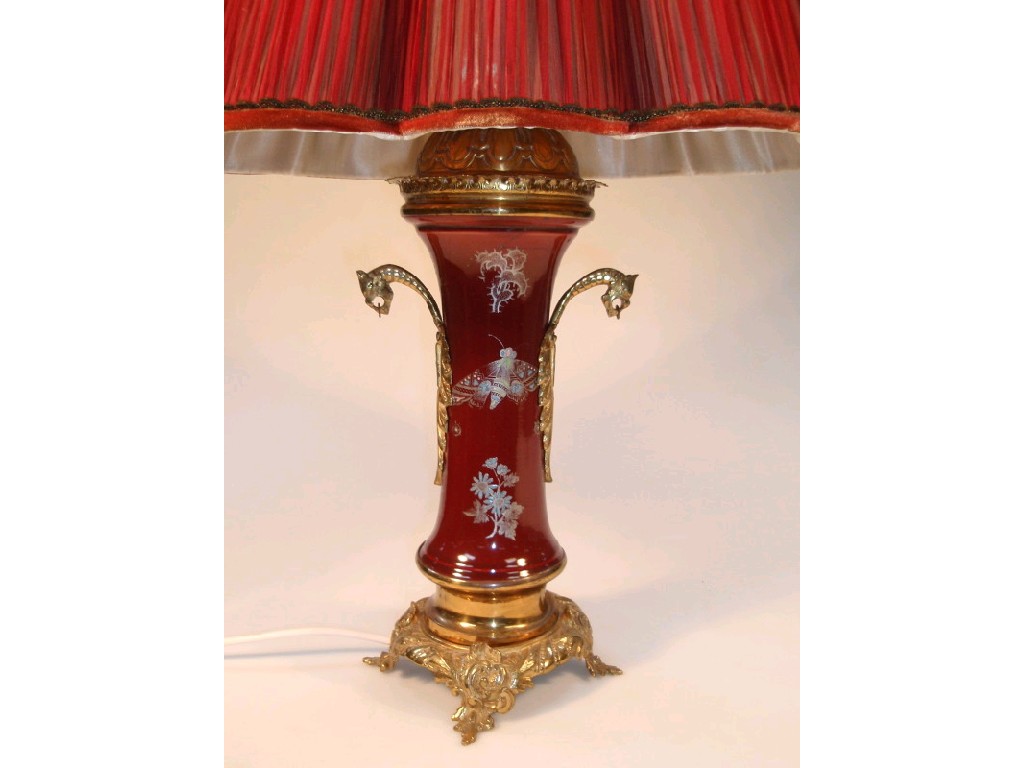 Appraisal: A table lamp with a magenta vase shape stem enamelled