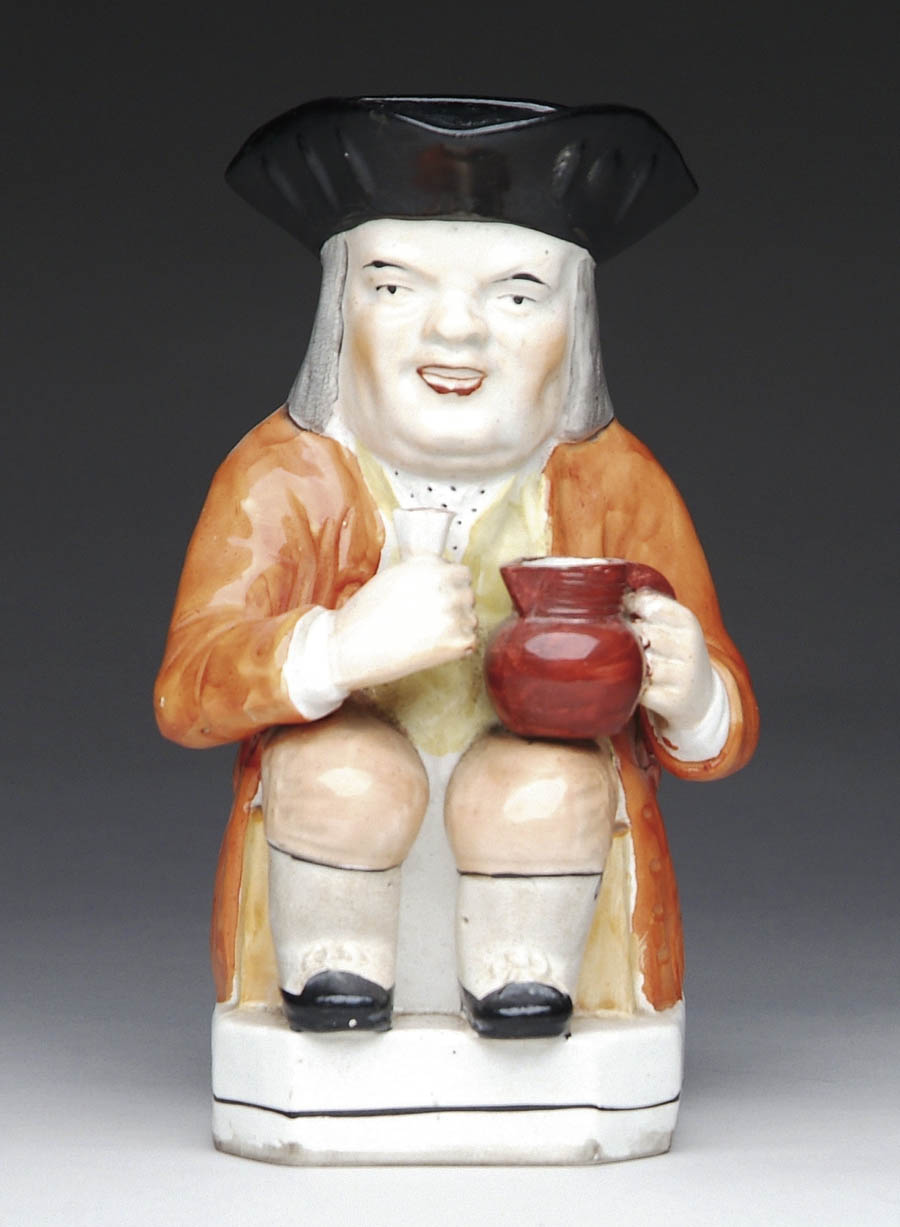 Appraisal: LARGE STAFFORDSHIRE TOBY JUG Orange jacketed man seated with red