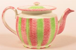 Appraisal: Red and Green Rainbow Spatter Teapot Squat form with slightly