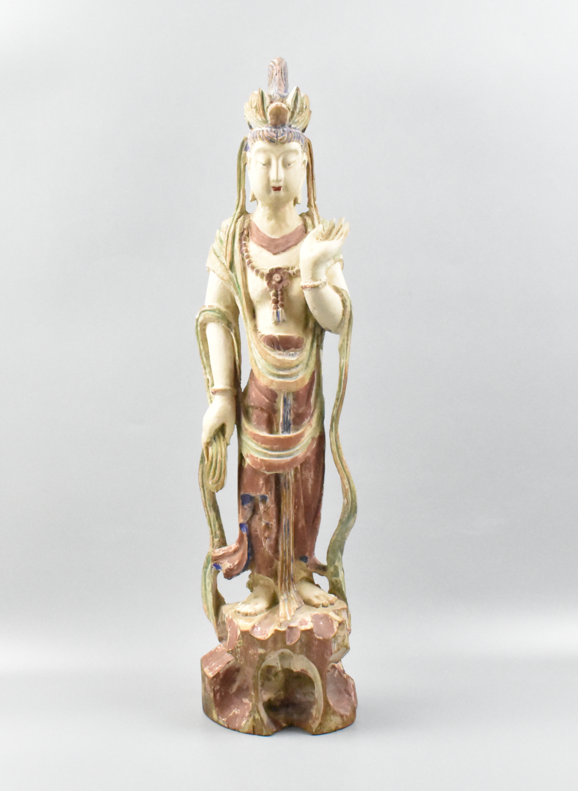 Appraisal: A Chinese lacquered wood Guanyin figure Standing on a naturalistic