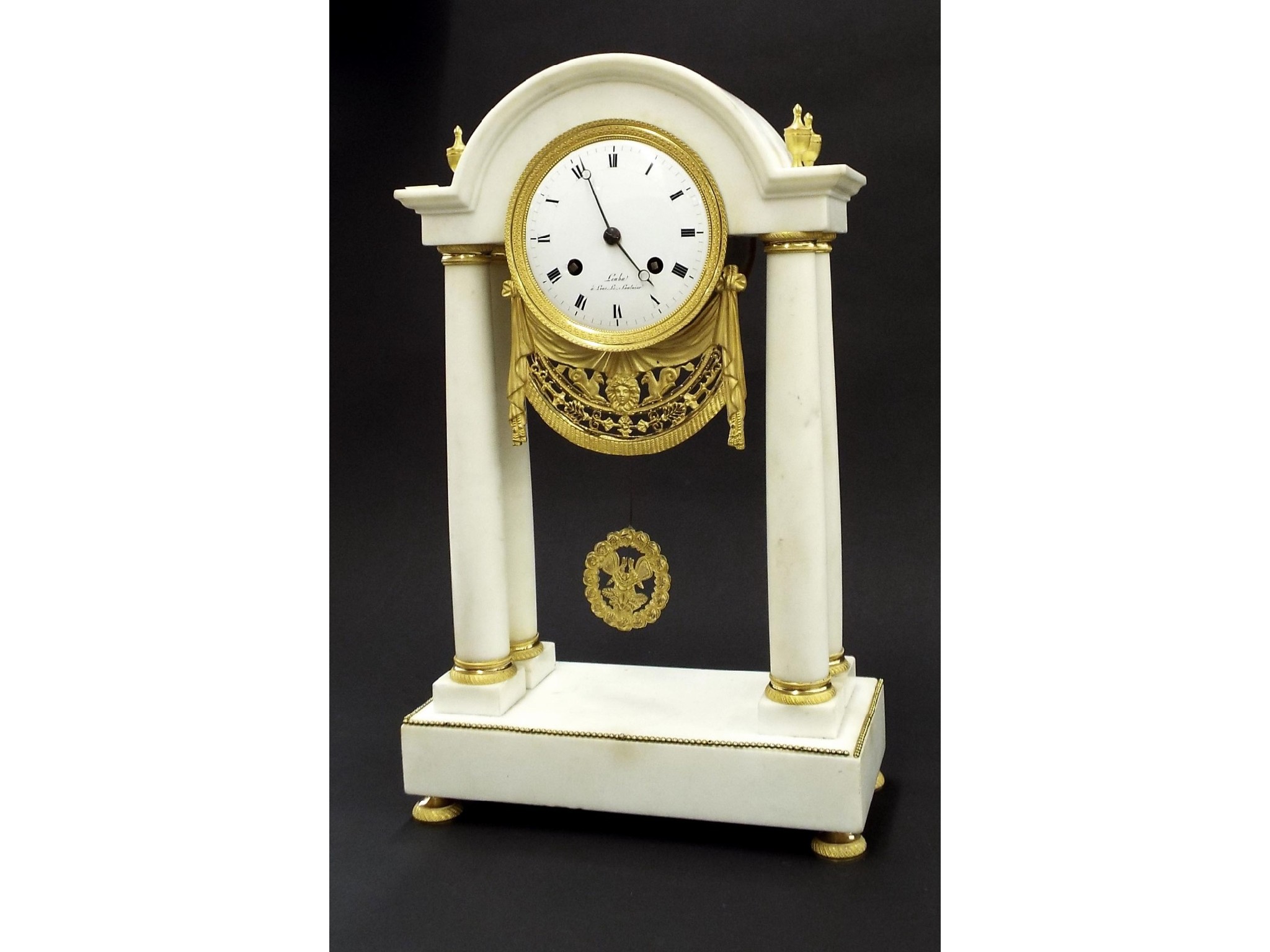 Appraisal: White marble two train portico mantel clock the movement with