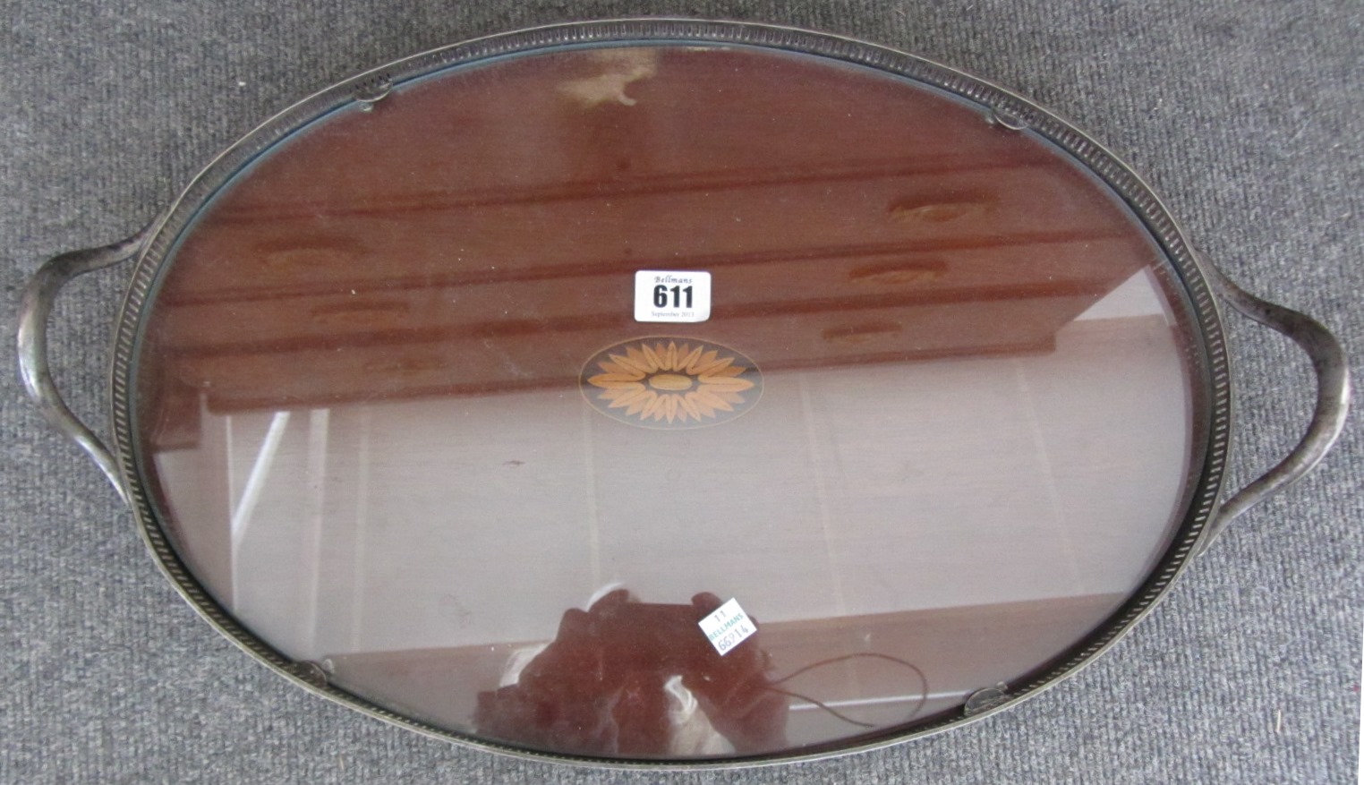 Appraisal: A late th century oval inlaid mahogany serving tray with