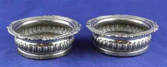 Appraisal: A pair of George IV silver wine coasters with fluted