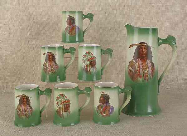 Appraisal: Porcelain pitcher set th c with Native American decoration tallest