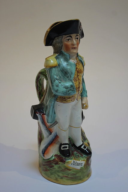 Appraisal: A STAFFORDSHIRE POTTERY GLAZED JUG in the form of Admiral