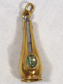 Appraisal: A Russian gold case cigar cutter with cabochon emerald thumb