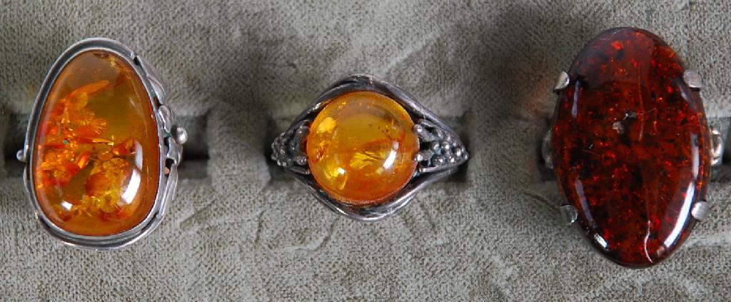 Appraisal: TWO SILVER RINGS each set with cabochon golden amber and