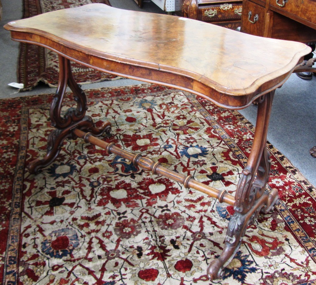 Appraisal: A Victorian walnut centre table of serpentine outline cm wide