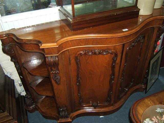 Appraisal: A Victorian walnut serpentine side cabinet with central panelled doors