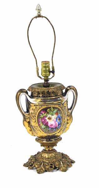 Appraisal: A French gilt metal mounted porcelain table lamp centered by