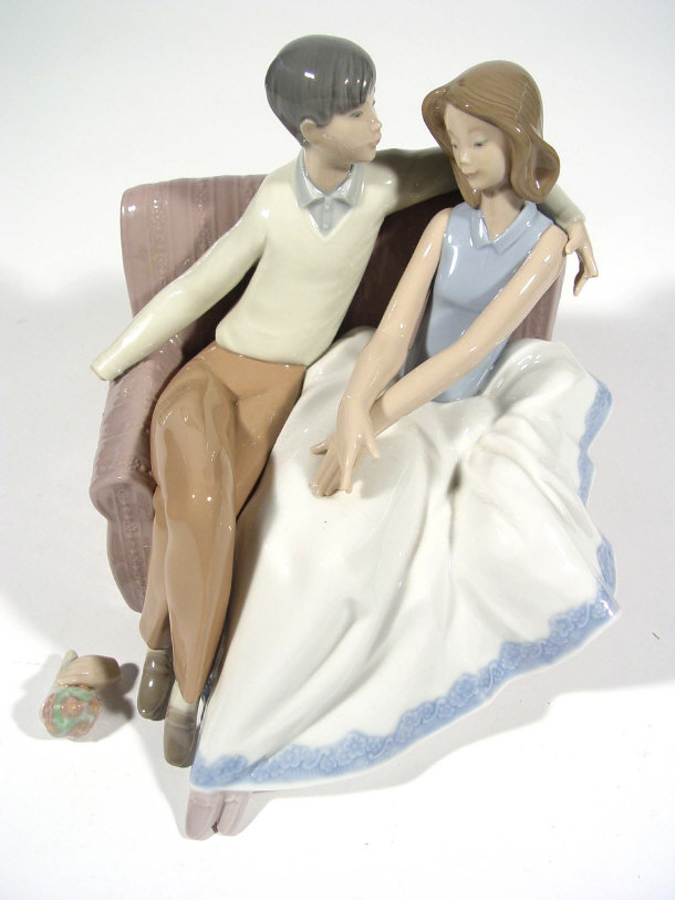 Appraisal: Hand painted Nao porcelain figure group of lovers seated on