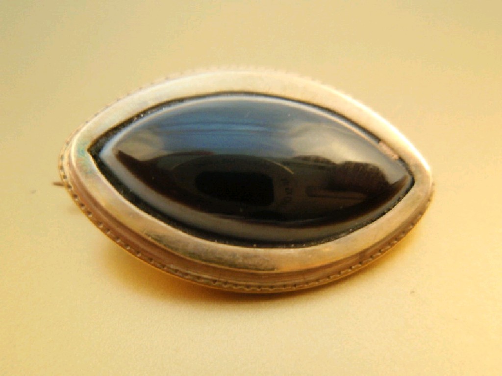 Appraisal: An elliptical bulls eye agate set memorial brooch inscription to