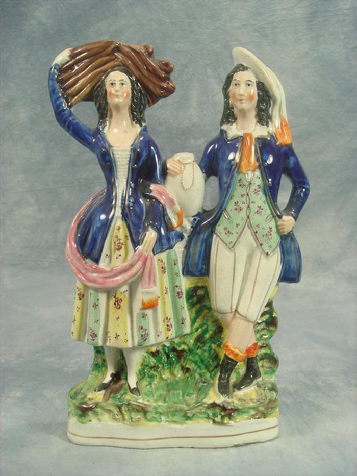 Appraisal: Staffordshire double figurine fancy couple woman with kindling man with