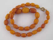 Appraisal: A graduated amber bead necklace largest bead approx x mm