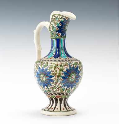 Appraisal: An Iznik Style Ewer Thickly potted ewer with a thin