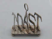 Appraisal: A four slice Victorian silver toast rack formed as the