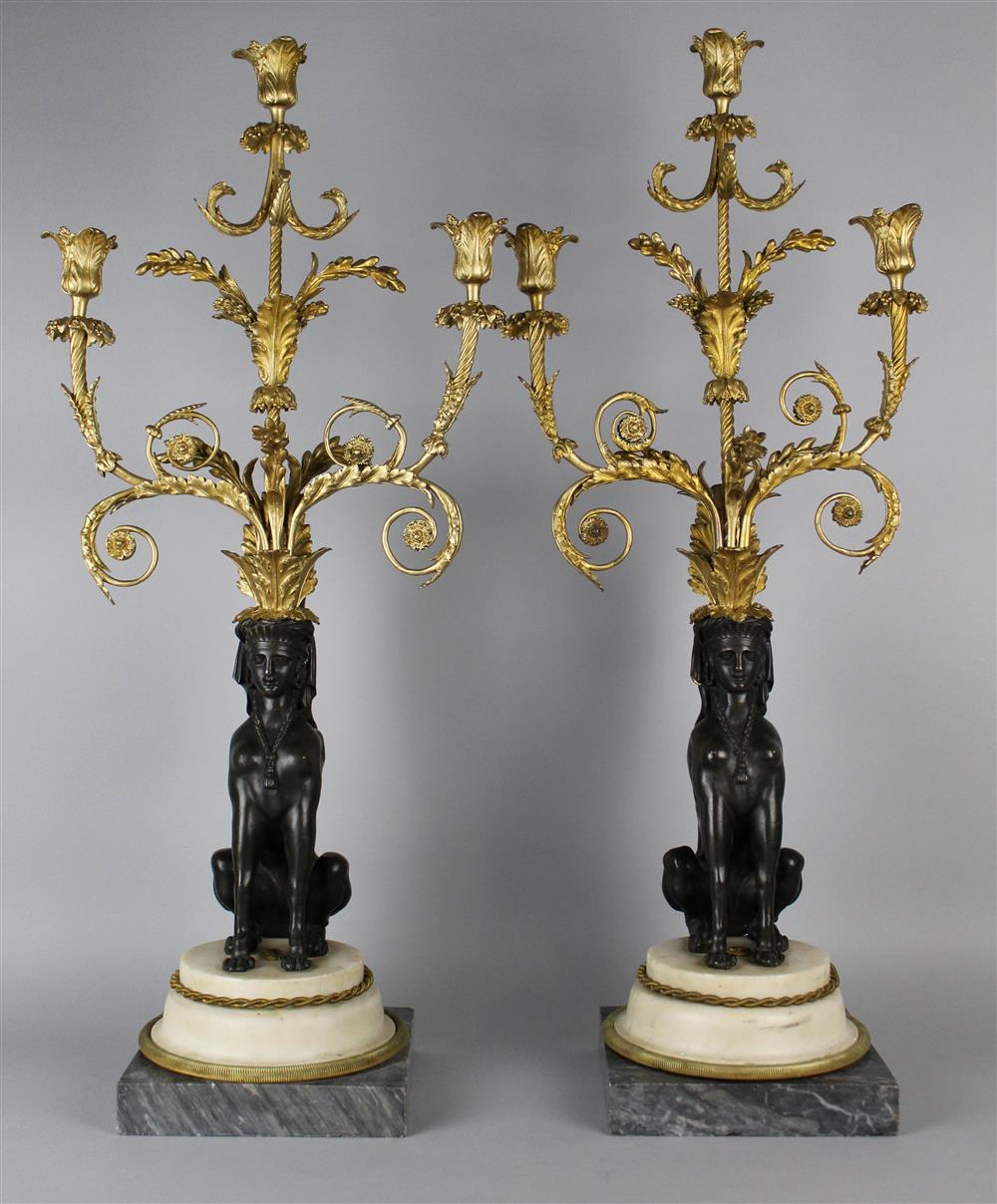 Appraisal: PAIR OF FRENCH EGYPTIAN REVIVAL THREE-LIGHT BRONZE PATINATED BRASS AND