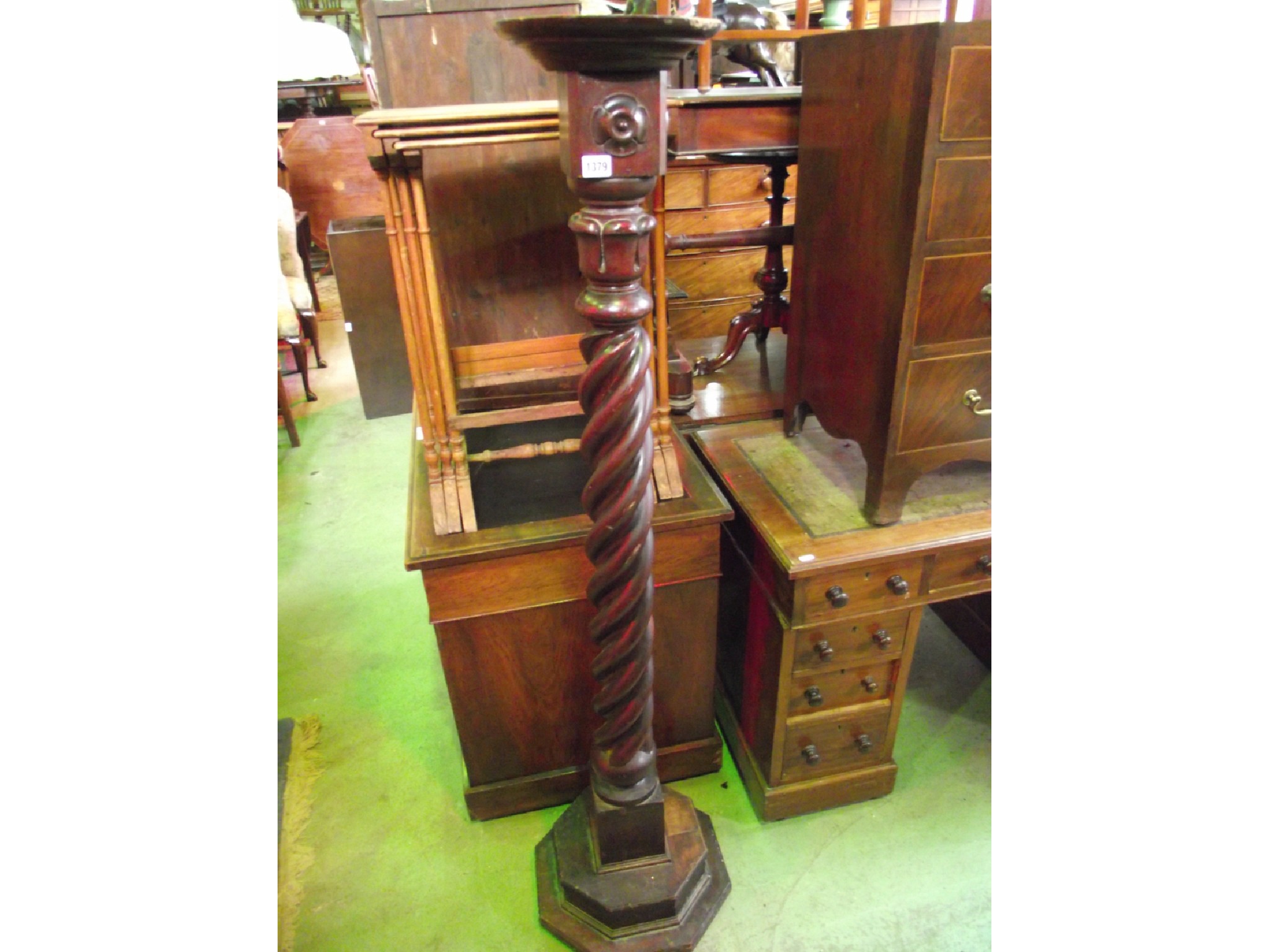 Appraisal: A mahogany torchere with spiral twist column and stepped octagonal