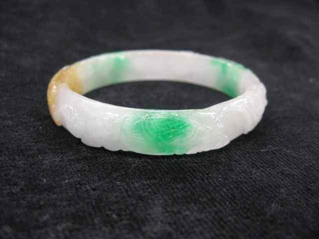 Appraisal: Carved Jade Bangle Bracelet mottled green white mm wide ''