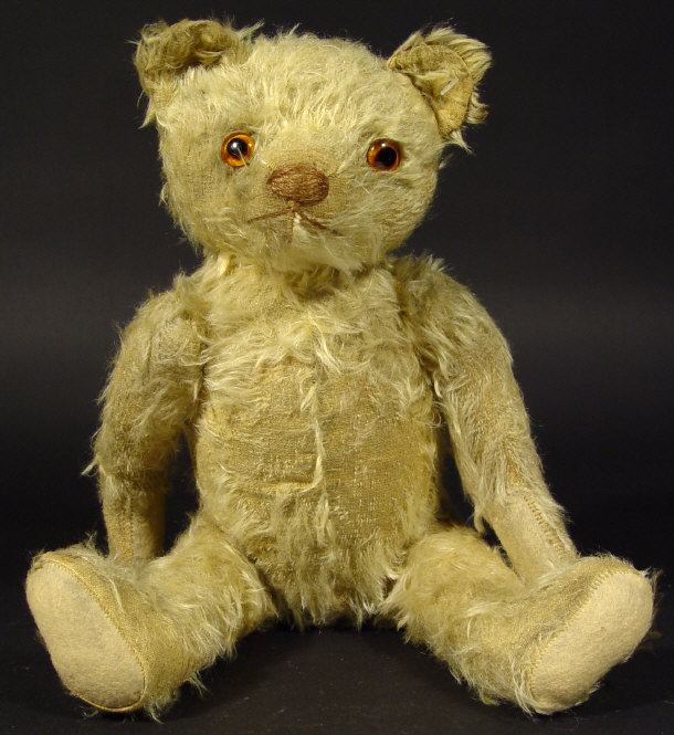 Appraisal: Edwardian straw filled teddy bear with jointed limbs glass eyes