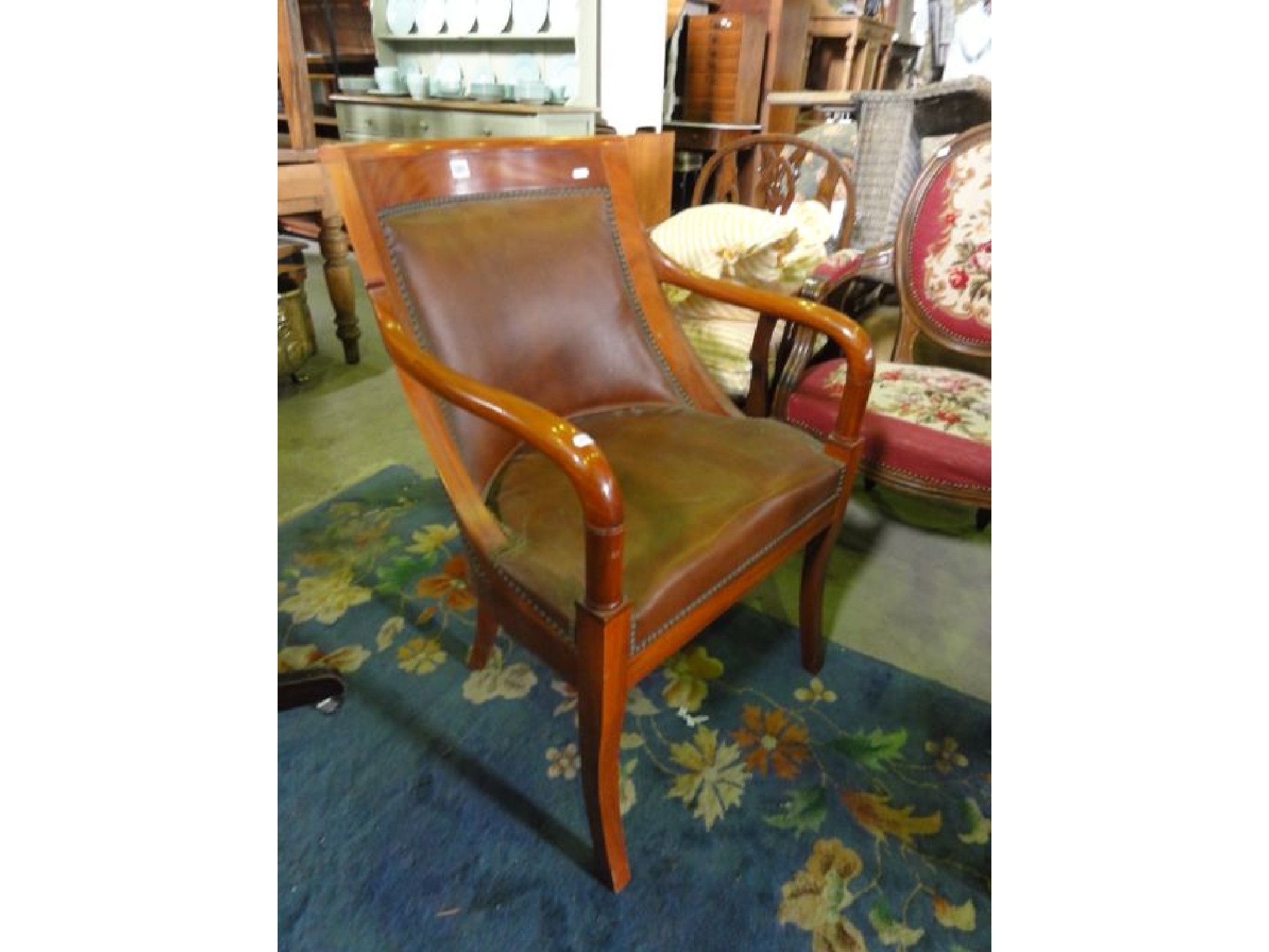 Appraisal: A reproduction mahogany library chair with faux leather upholstered seat