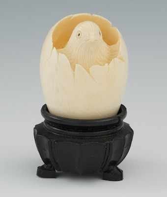 Appraisal: A Chinese Carved Ivory Hatched Egg with Chick Inside on