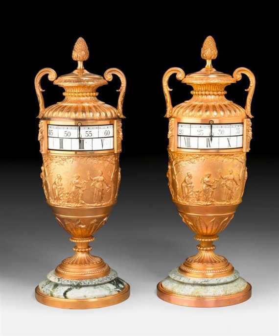 Appraisal: PAIR OF VASE CLOCKS AUX CERCLES TOURNANTS Louis XVI style