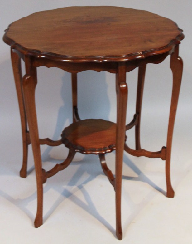 Appraisal: An Edwardian walnut and mahogany occasional table the shaped piecrust