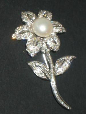 Appraisal: A PEARL AND DIAMOND BROOCH modelled as a single flower