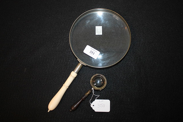 Appraisal: AN OUTSIZED MAGNIFYING GLASS cm in diameter with turned ivory