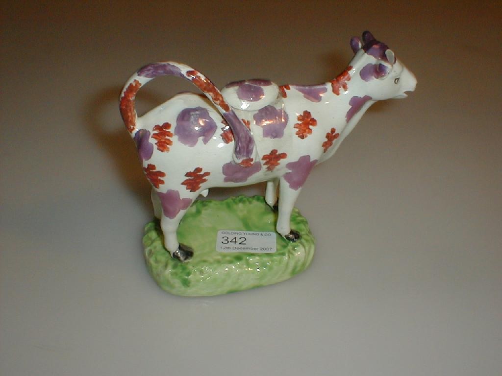 Appraisal: A th century purple lustre pottery cow creamer