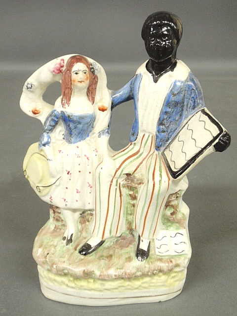 Appraisal: - Staffordshire seated Uncle Tom and Eva c h x