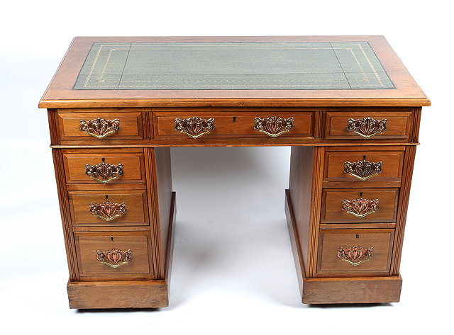 Appraisal: AN EDWARDIAN OAK PEDESTAL DESK the top with green Morocco