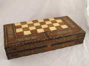 Appraisal: A hardwood games compendium with chess draughts and backgammon boards