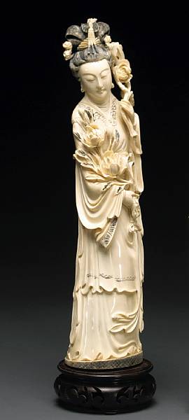 Appraisal: A tinted ivory beauty th Century The standing figure holding