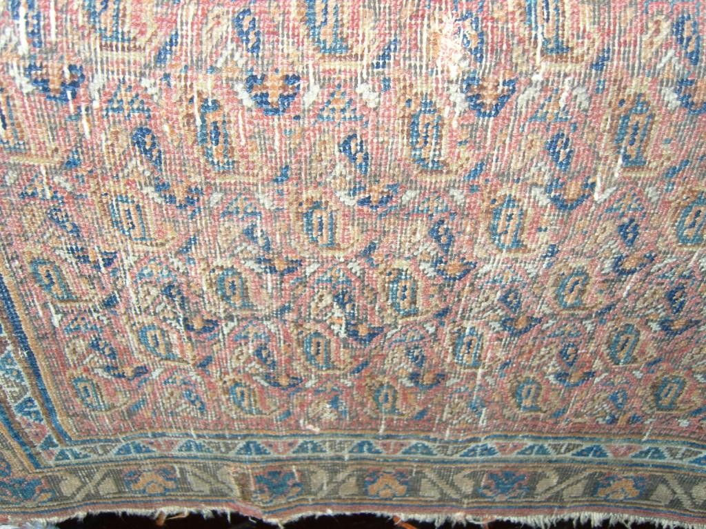 Appraisal: A small eastern wool rug with repeating border decoration within