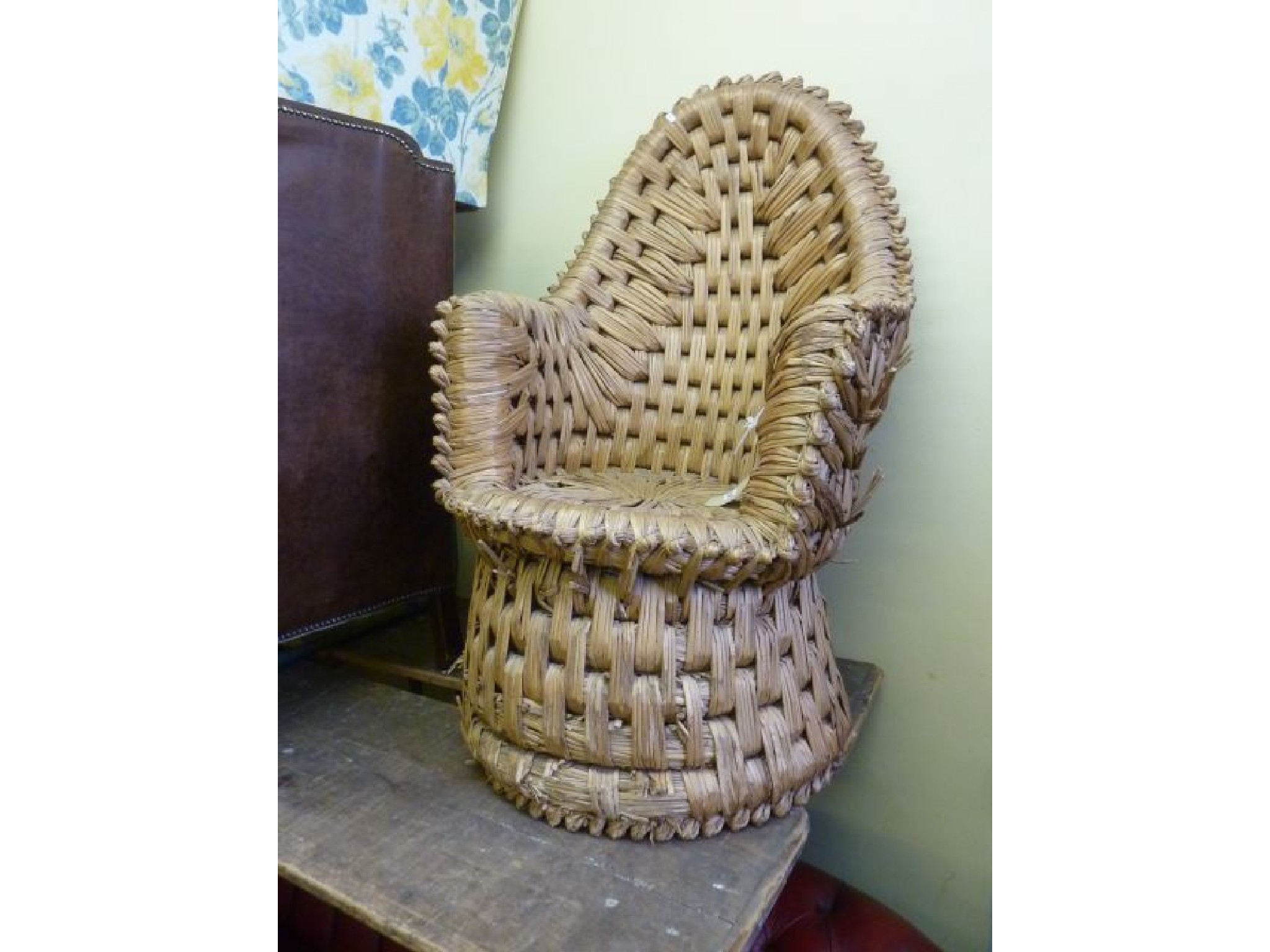 Appraisal: An unusual rushwork armchair with arched back the structure of