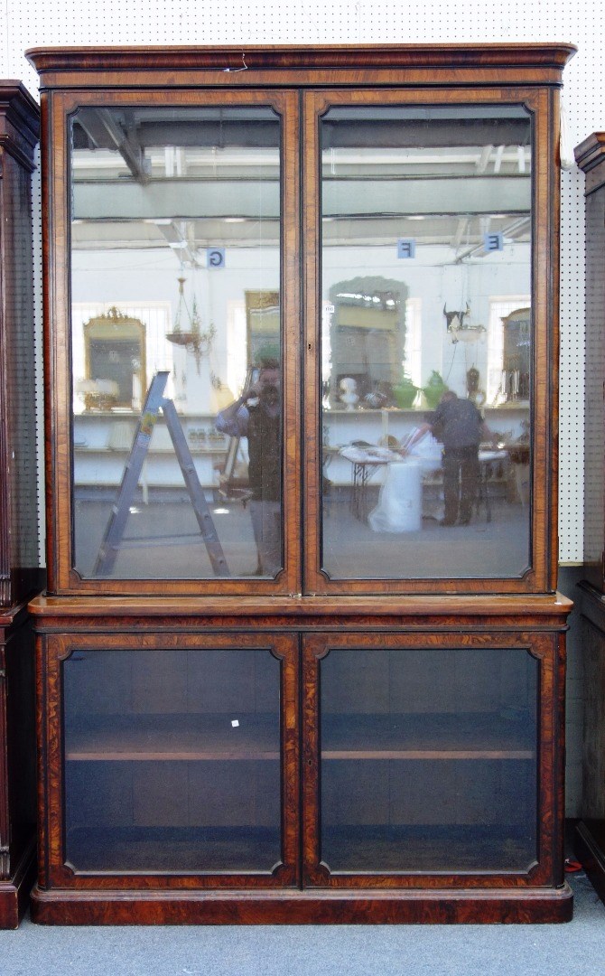 Appraisal: A Victorian figured walnut double height bookcase display cabinet over