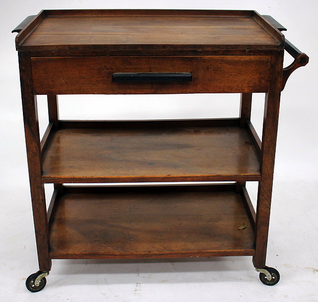 Appraisal: AN EARLY TH CENTURY TEA TROLLEY with removable tray towel