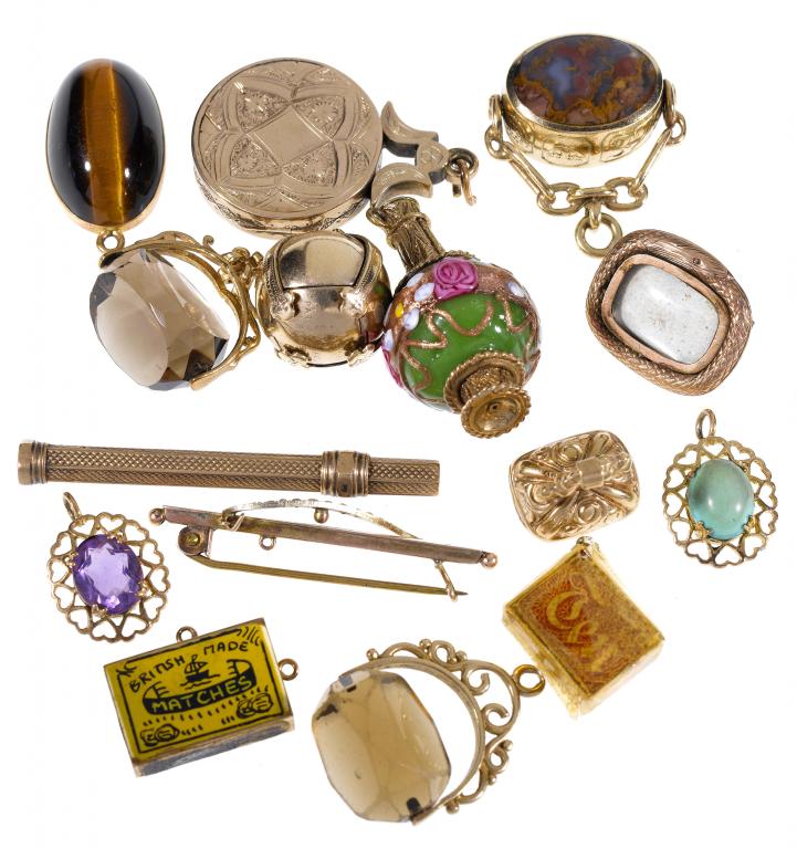 Appraisal: A GOLD AND HELIOTROPE LOCKET THREE GOLD SWIVEL SEALS AND