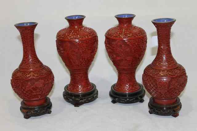 Appraisal: A PAIR OF CHINESE CINNABAR LACQUER CARVED BALUSTER VASES on