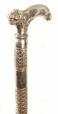 Appraisal: An Egyptian white metal cane the handle modelled as a