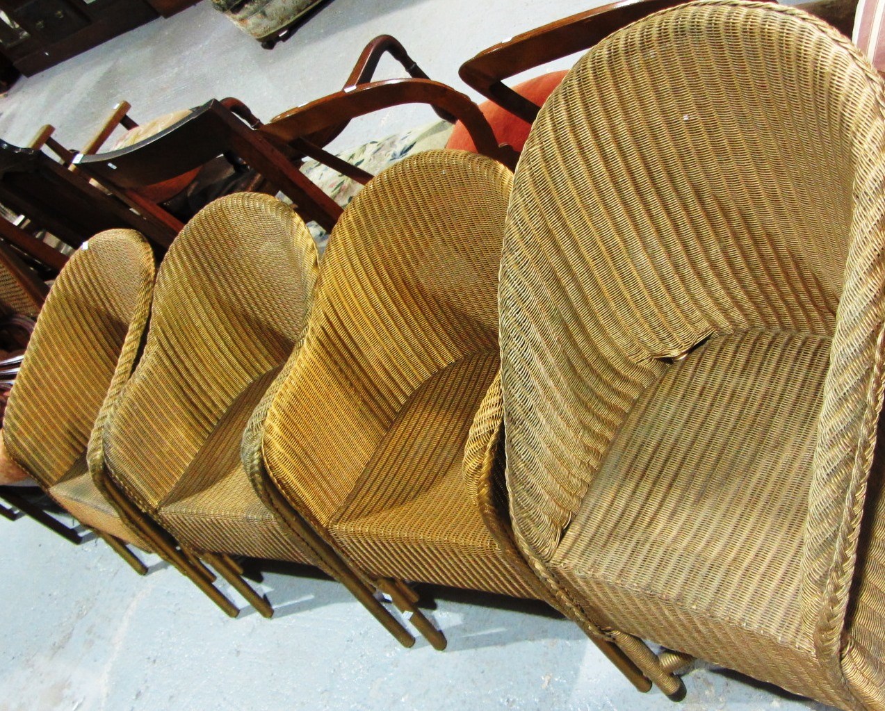 Appraisal: A set of three gold painted Lloyd Loom style chairs