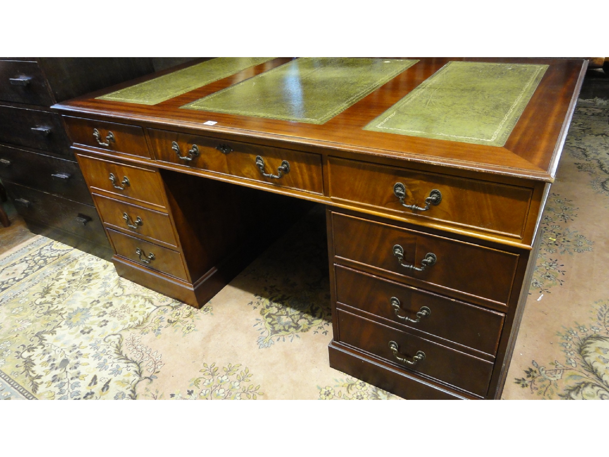 Appraisal: A reproduction mahogany veneered twin pedestal writing desk in the