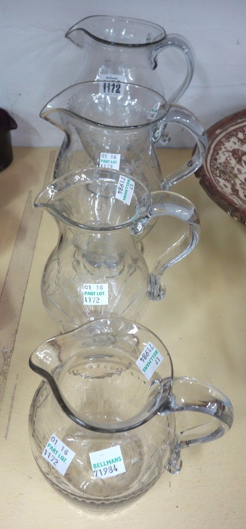 Appraisal: Four English engraved glass jugs late th early th century