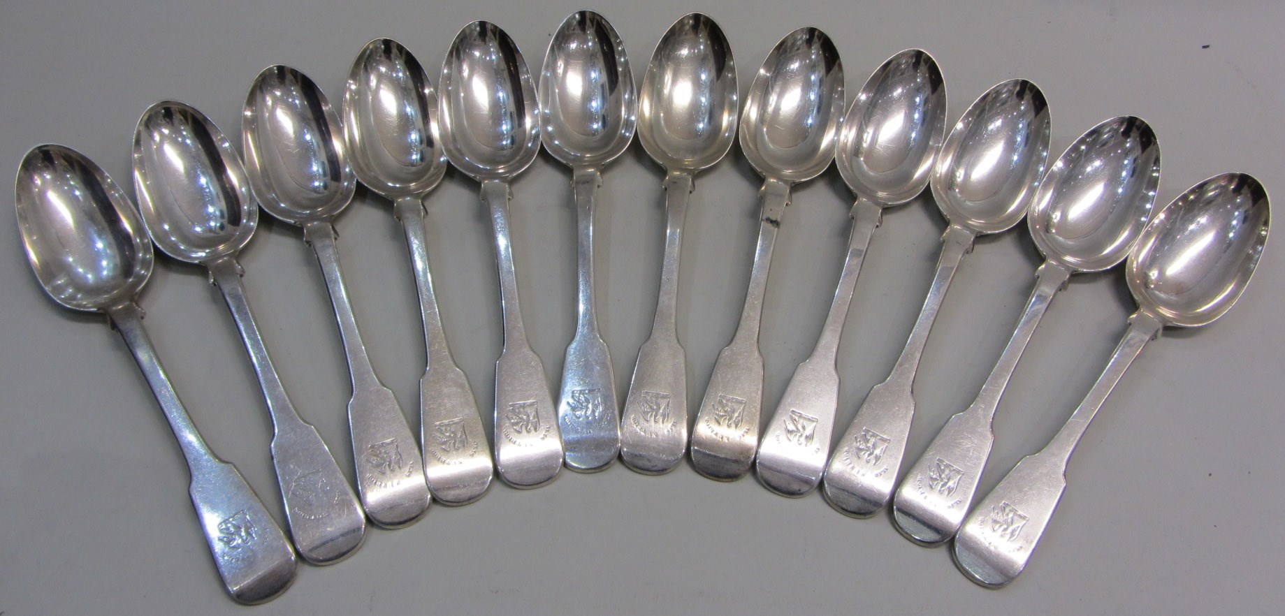 Appraisal: Twelve Scottish silver fiddle pattern tablespoons all crest and motto