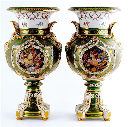 Appraisal: Pair Continental porcelain urns vase forms on pedestal bases decorated