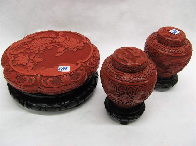 Appraisal: THREE CHINESE CARVED CINNABAR ART OBJECTS all with hardwood display