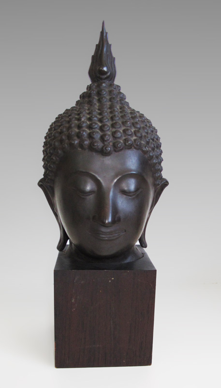 Appraisal: BRONZE HEAD DEPICTING BUDDHA Mounted on a block of wood